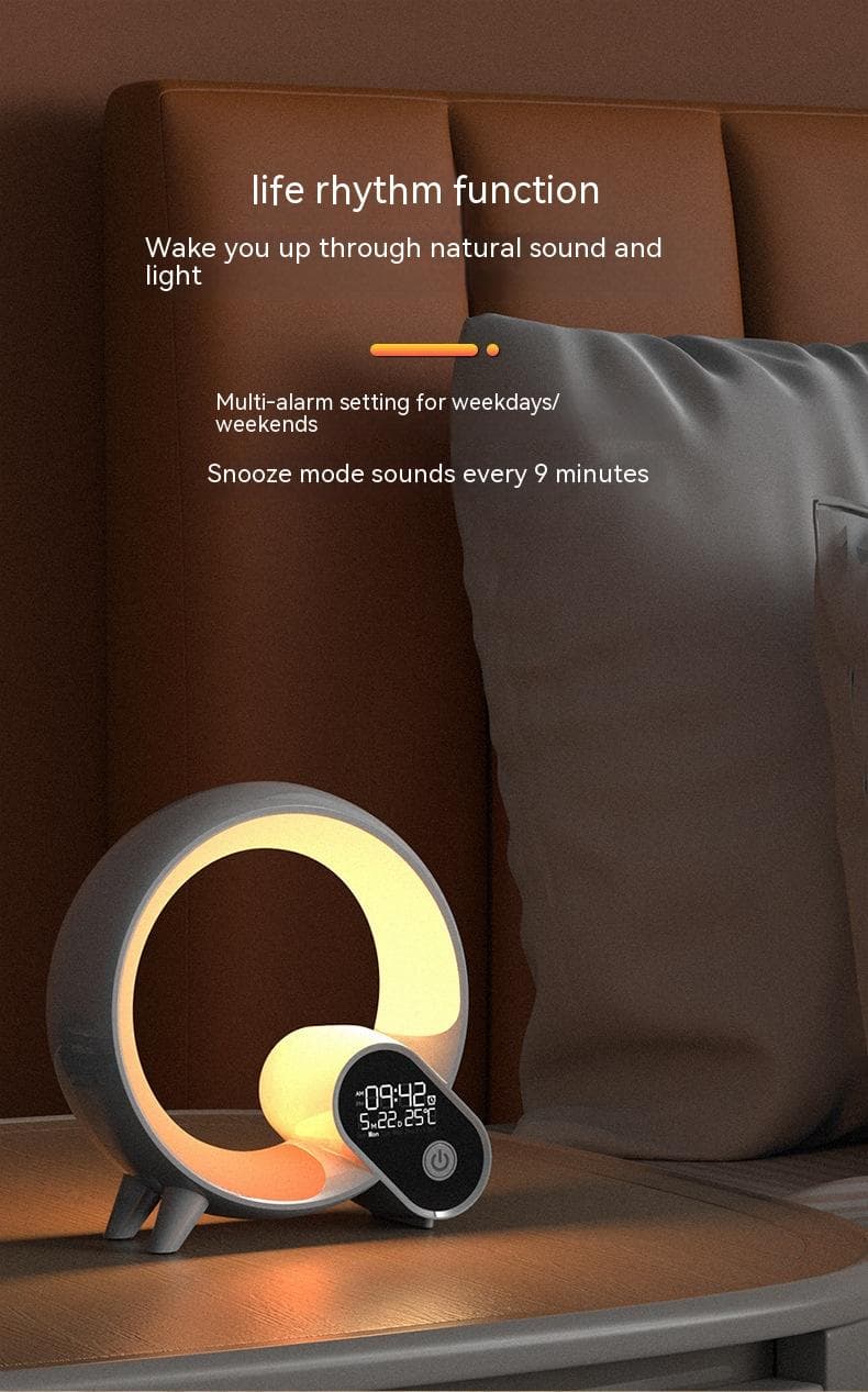 Lamp glowing warm orange next to a bed, alarm and snooze function shown